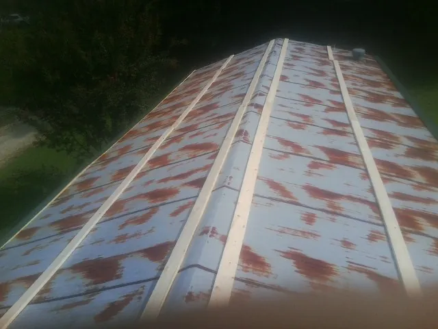 Rusted metal roof panels with new wood purlins before replacement — Storm Damage Roof Repair in Mishawaka by Roofing Brothers