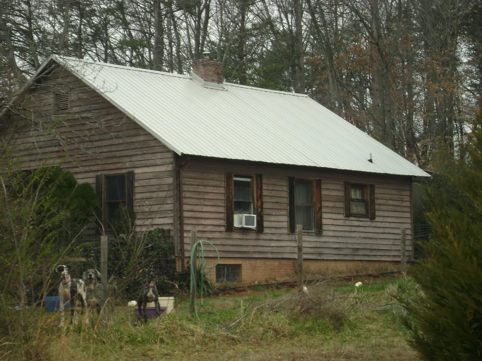 White metal roof on an old wood sided farmhouse, from a Metal Roof Installation job in Mishawaka